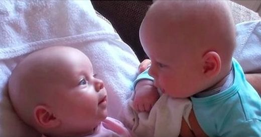 Twin Babies Make Eye Contact While Deep In Conversation
