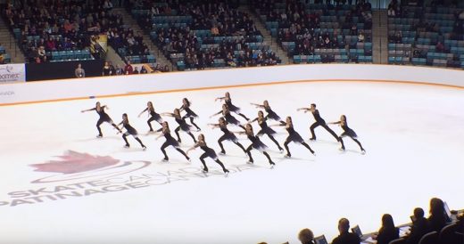 16 Synchronized Ice Skaters Glide Across The Ice To “Bohemian Rhapsody”